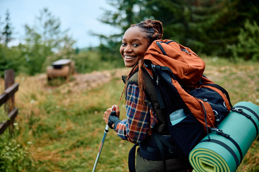 woman backpacking with all of her gear on her back, perfect for the zombie apocalypse