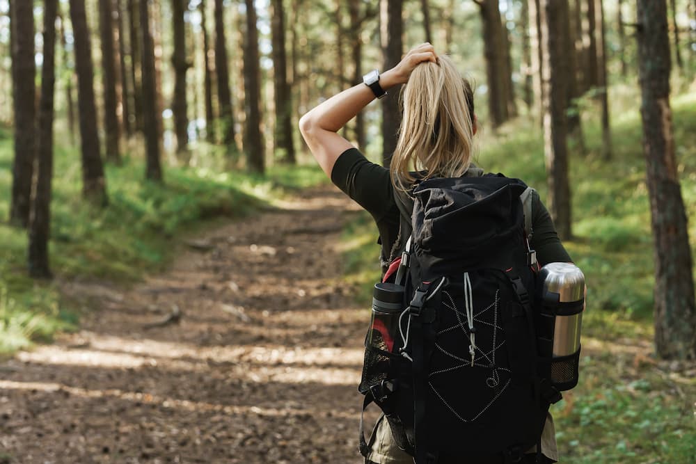 female hiker looks at long trail ahead